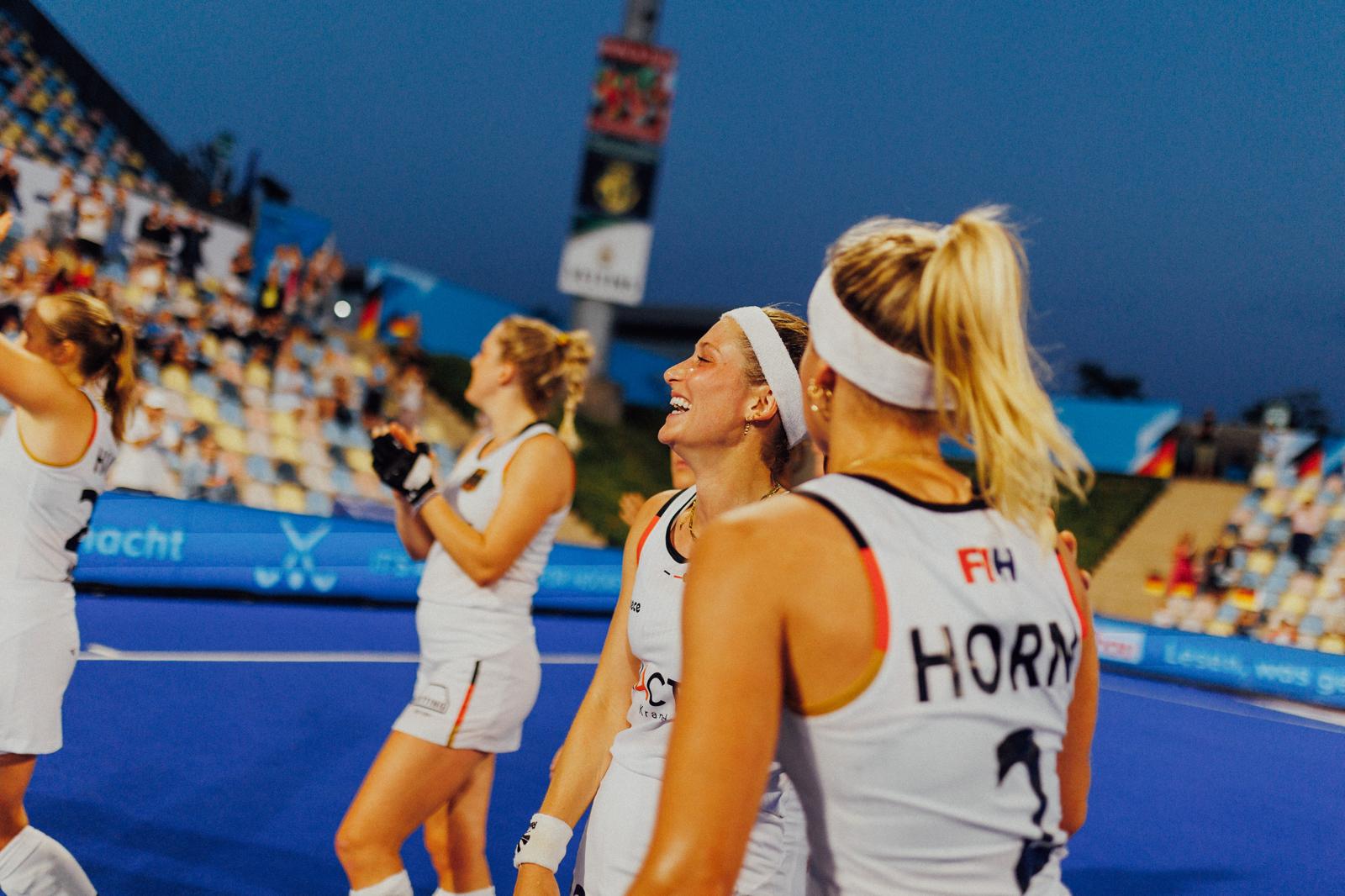 Cécile celebrating with her national team under stadium lights